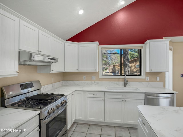 3792 E Ramble Wood Dr, Flagstaff, AZ 86004 - kitchen featuring lofted ceiling, stainless steel appliances, under cabinet range hood, a sink, and white cabinets