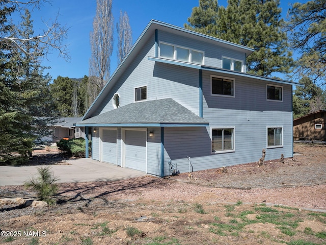 3792 E Ramble Wood Dr, Flagstaff, AZ 86004 - rear view of house featuring driveway and a garage
