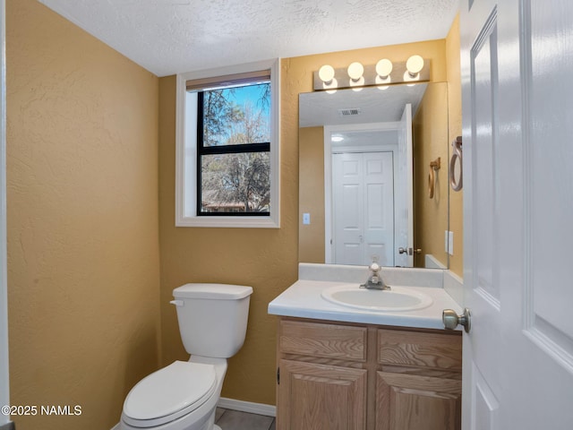3792 E Ramble Wood Dr, Flagstaff, AZ 86004 - bathroom featuring vanity, toilet, a textured wall, a textured ceiling, and visible vents
