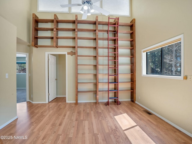 3792 E Ramble Wood Dr, Flagstaff, AZ 86004 - spare room featuring baseboards, a high ceiling, visible vents, a ceiling fan, and wood finished floors
