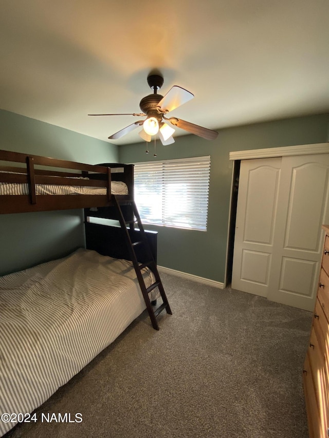 bedroom featuring ceiling fan and dark colored carpet