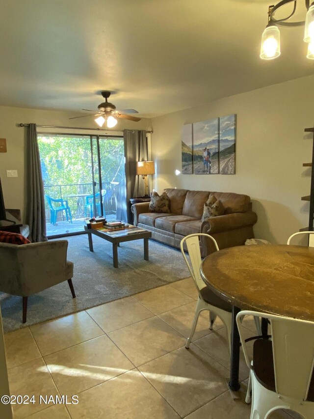 living room with ceiling fan and light tile patterned floors