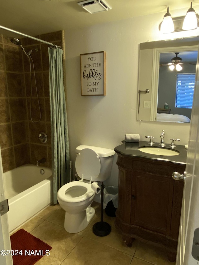 full bathroom featuring vanity, toilet, shower / bath combo with shower curtain, and tile patterned flooring