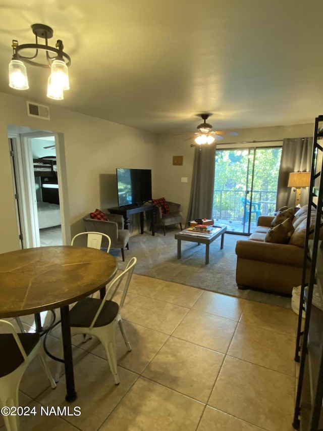 tiled living room with ceiling fan