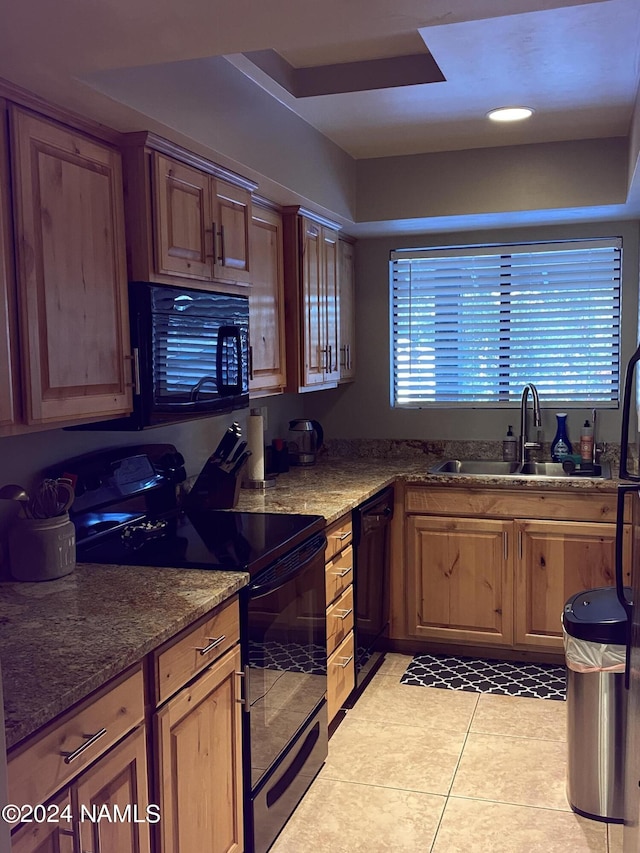 kitchen featuring sink, black appliances, light tile patterned floors, and stone counters