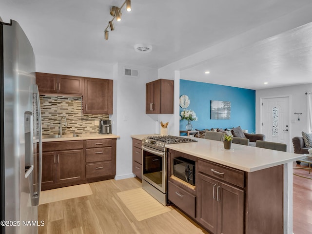 2821 N Tindle Blvd, Flagstaff, AZ 86004 - kitchen featuring a sink, a peninsula, open floor plan, and stainless steel appliances