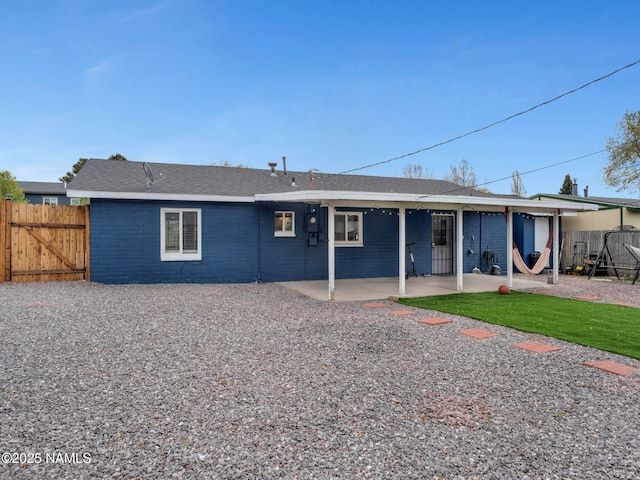 2821 N Tindle Blvd, Flagstaff, AZ 86004 - back of house featuring a patio, a gate, fence, and brick siding