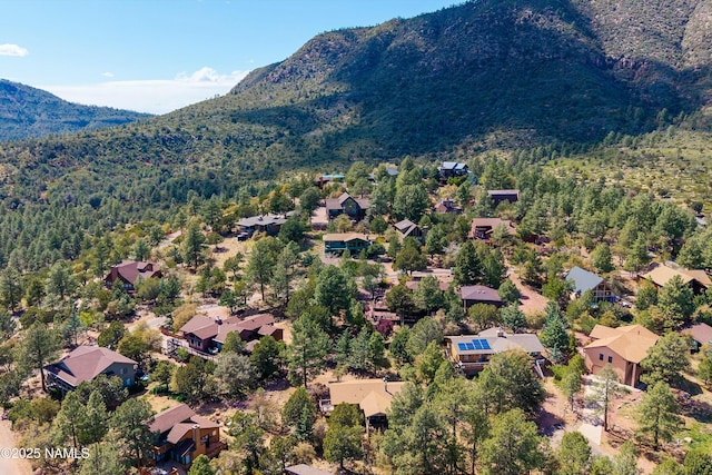 birds eye view of property featuring a wooded view, a residential view, and a mountain view