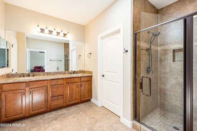 bathroom with vanity and a shower with shower door