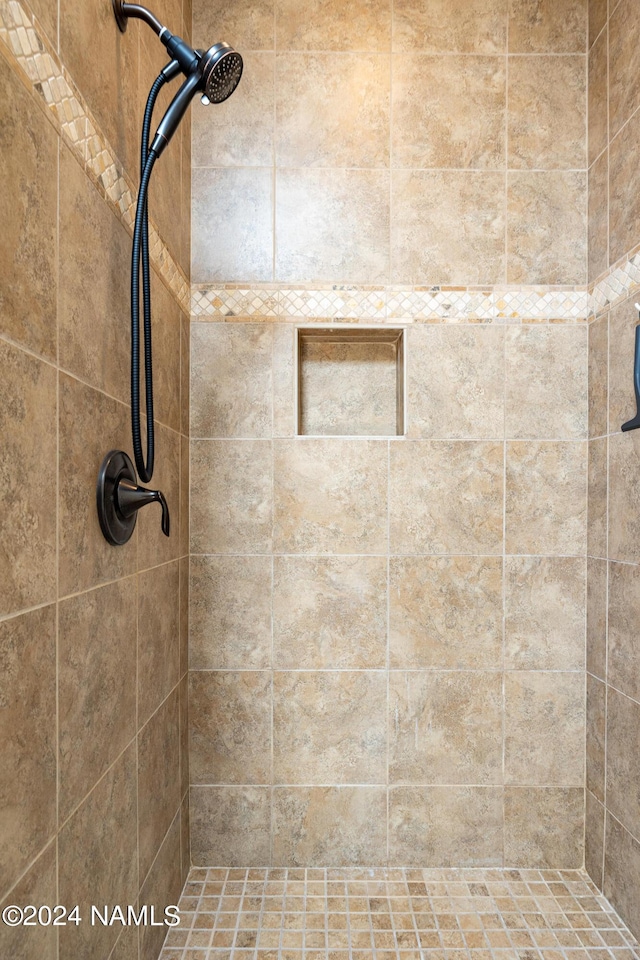 bathroom with a tile shower