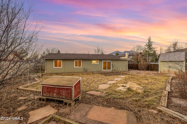 view of back house at dusk