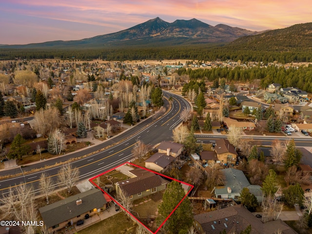 aerial view at dusk featuring a mountain view