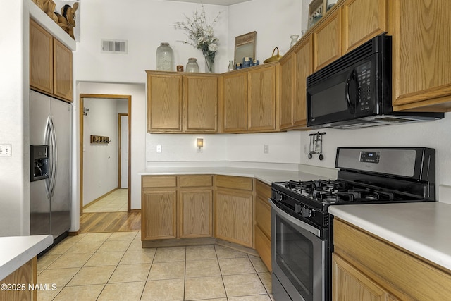 6162 Meadows Ln, Flagstaff, AZ 86004 - kitchen featuring light countertops, visible vents, and appliances with stainless steel finishes