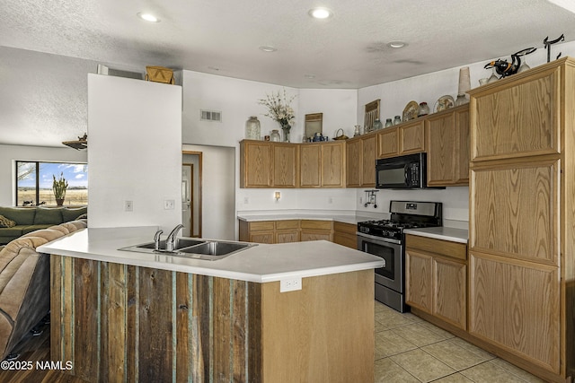 6162 Meadows Ln, Flagstaff, AZ 86004 - kitchen featuring visible vents, black microwave, light tile patterned floors, gas stove, and a sink