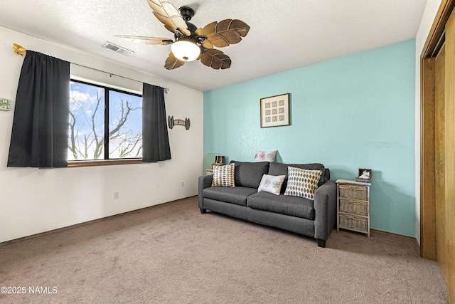 6162 Meadows Ln, Flagstaff, AZ 86004 - living area featuring a ceiling fan, carpet, visible vents, and a textured ceiling