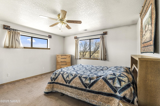 6162 Meadows Ln, Flagstaff, AZ 86004 - bedroom with visible vents, a ceiling fan, a textured ceiling, carpet, and baseboards
