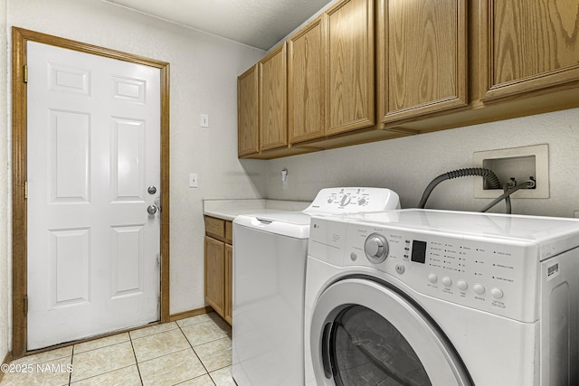 6162 Meadows Ln, Flagstaff, AZ 86004 - laundry area featuring light tile patterned floors, cabinet space, and washer and dryer