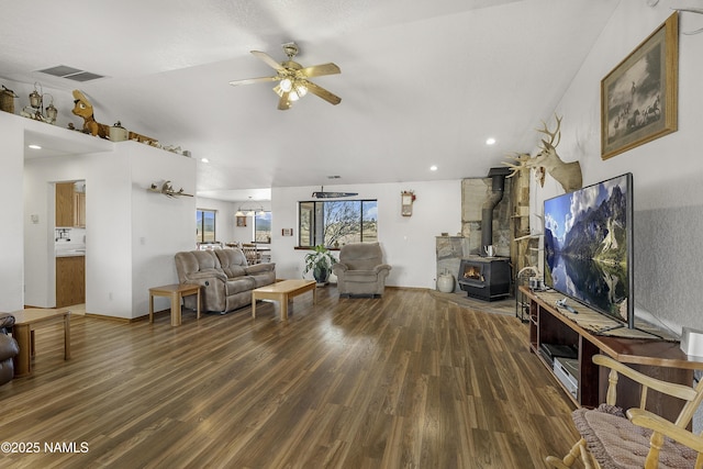 6162 Meadows Ln, Flagstaff, AZ 86004 - living room featuring a wood stove, wood finished floors, visible vents, and ceiling fan