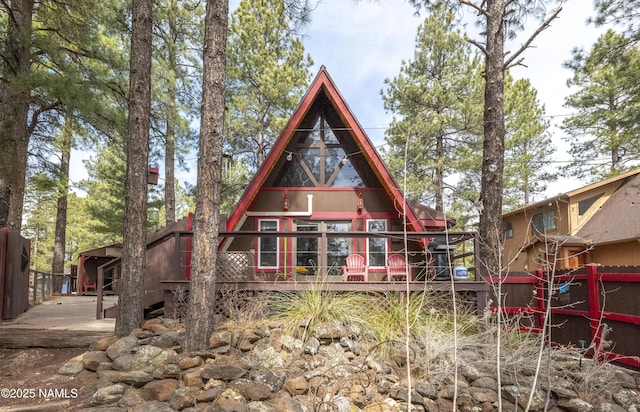rear view of property with fence and a deck