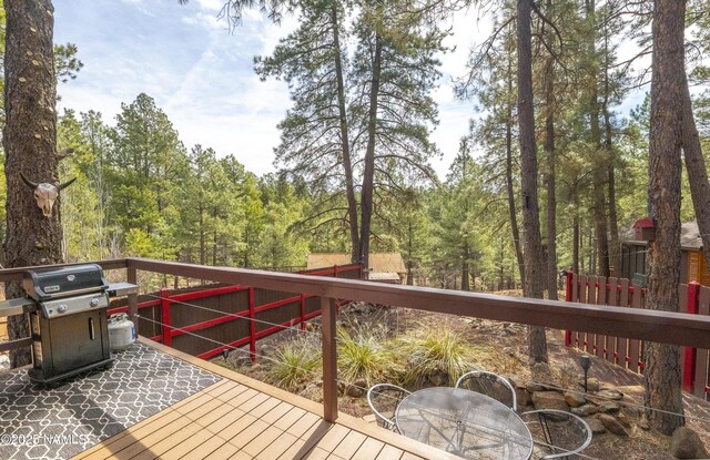 wooden deck featuring a grill