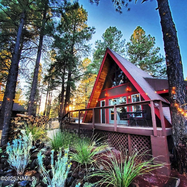 rear view of property featuring a deck