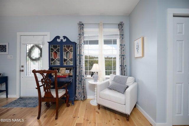 dining area with baseboards and light wood-style floors
