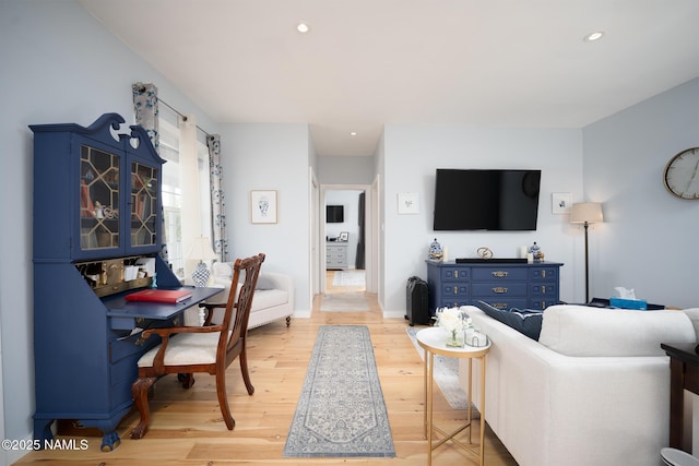 living room with baseboards, recessed lighting, and light wood finished floors