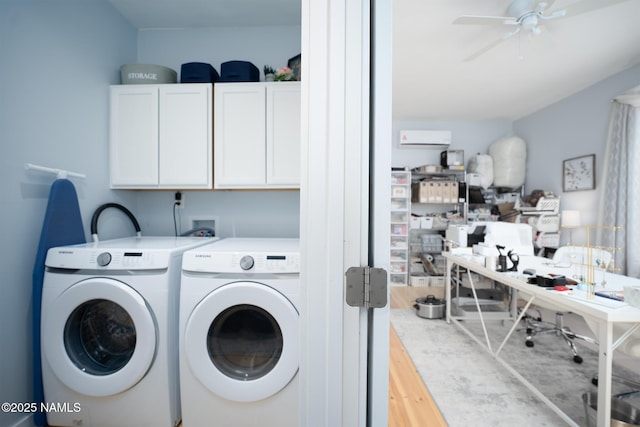 laundry room with ceiling fan, wood finished floors, washing machine and clothes dryer, and cabinet space