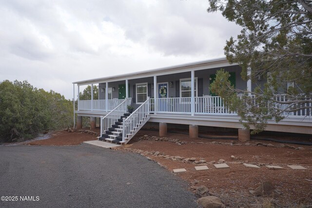 view of front of house with stairs and a porch
