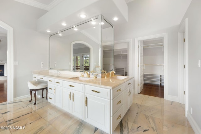 1430 E Puma Pl Unit F, Munds Park, AZ 86017 - full bath with marble look tile flooring, vanity, a spacious closet, recessed lighting, and ornamental molding