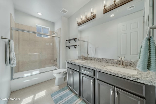 bathroom featuring double vanity, visible vents, and a sink