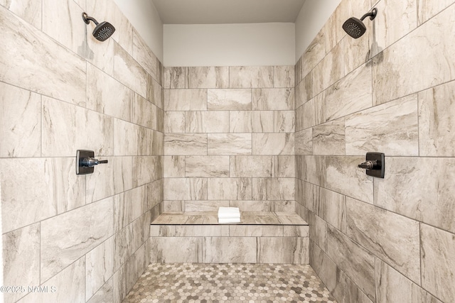 full bath featuring tiled shower