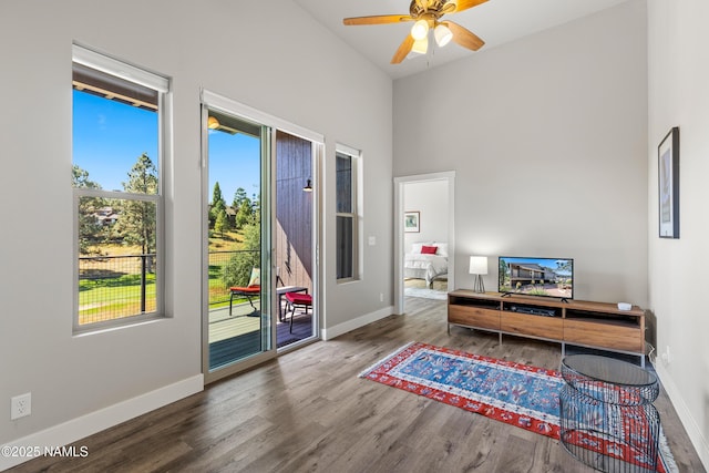 office featuring a high ceiling, baseboards, and wood finished floors