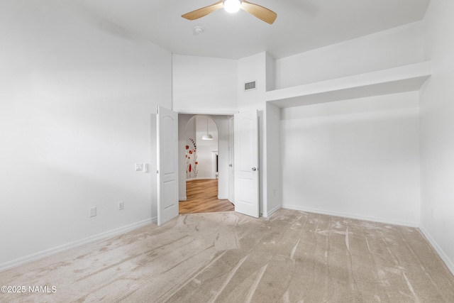1401 N 4th St Unit 228, Flagstaff, AZ 86004 - unfurnished bedroom featuring carpet flooring, baseboards, a ceiling fan, and arched walkways