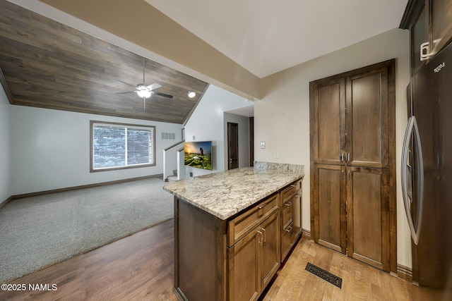 1200 S Riordan Ranch St Unit 36, Flagstaff, AZ 86001 - kitchen featuring baseboards, freestanding refrigerator, light wood-style floors, and lofted ceiling