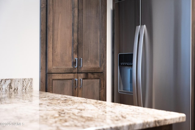 1200 S Riordan Ranch St Unit 36, Flagstaff, AZ 86001 - room details with stainless steel refrigerator with ice dispenser, dark brown cabinetry, and light stone countertops