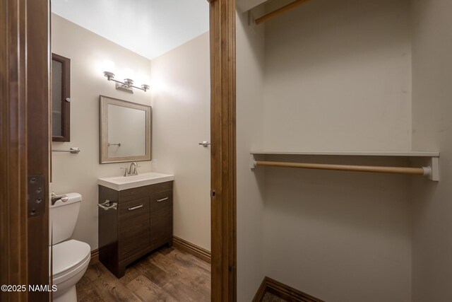 1200 S Riordan Ranch St Unit 36, Flagstaff, AZ 86001 - bathroom with vanity, toilet, and wood finished floors