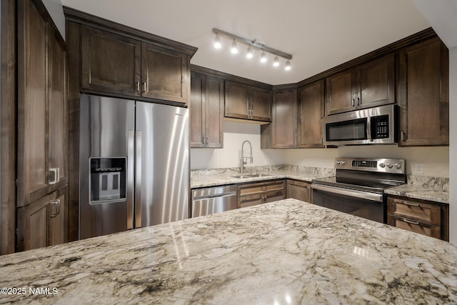 1200 S Riordan Ranch St Unit 36, Flagstaff, AZ 86001 - kitchen featuring a sink, dark brown cabinetry, light stone counters, and stainless steel appliances