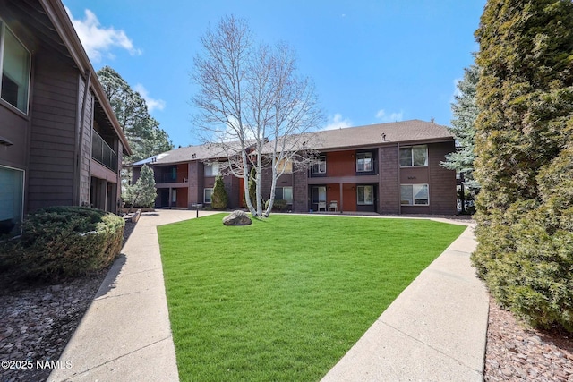 1200 S Riordan Ranch St Unit 36, Flagstaff, AZ 86001 - exterior space featuring a yard and brick siding