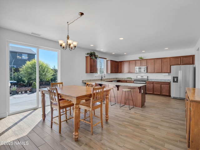 4580 Centaurus Rd, Bellemont, AZ 86015 - dining space featuring light wood-type flooring, visible vents, an inviting chandelier, and recessed lighting