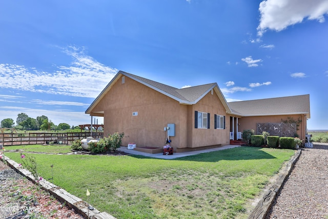 view of side of home with a lawn