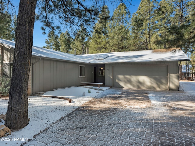 view of front facade featuring a garage and decorative driveway