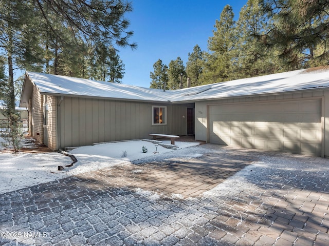 view of front of house featuring decorative driveway and an attached garage