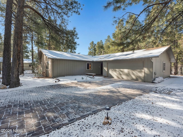 view of front of home featuring decorative driveway and an attached garage