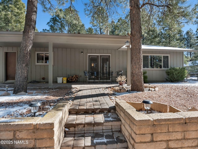 back of property featuring board and batten siding and a patio area