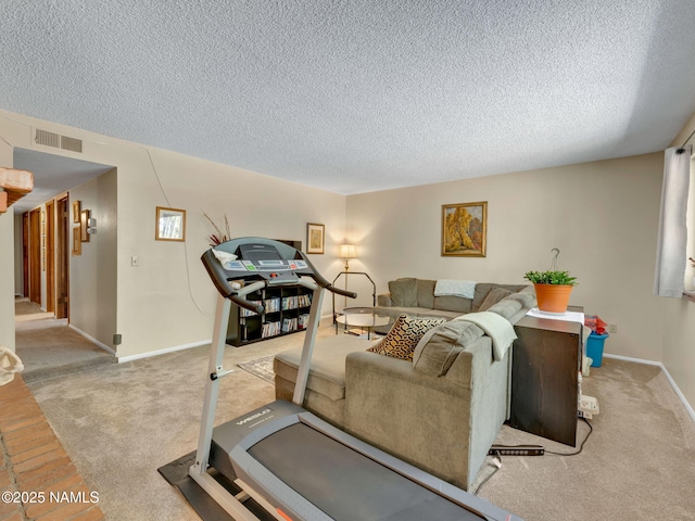 exercise room with a textured ceiling, carpet flooring, visible vents, and baseboards