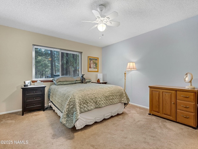 bedroom with baseboards, a textured ceiling, and light colored carpet