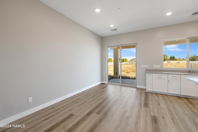 interior space with sink and light hardwood / wood-style floors