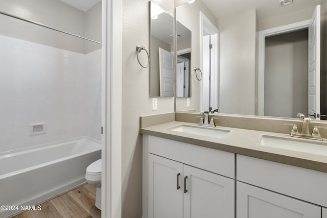 full bathroom with vanity, toilet, bathtub / shower combination, and wood-type flooring