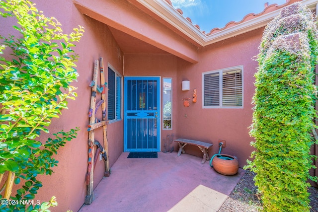 doorway to property with a patio